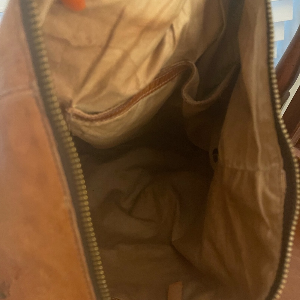 Leather backpack with adjustable straps that can be a crossbody or a backpack.